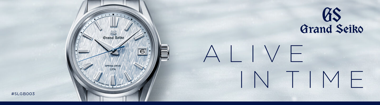Image of a silver Grand Seiko wristwatch with a light blue textured dial and blue hands shown against a soft grey background